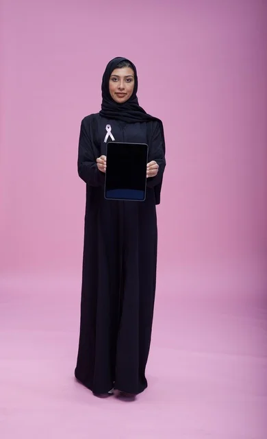 Saudi Woman with Tablet and Breast Cancer Ribbon