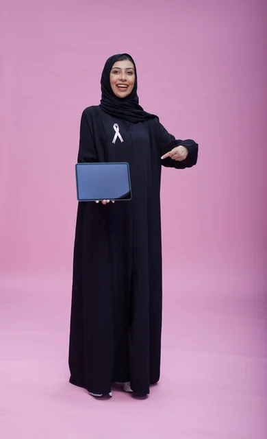 Saudi Woman with Tablet and Breast Cancer Ribbon
