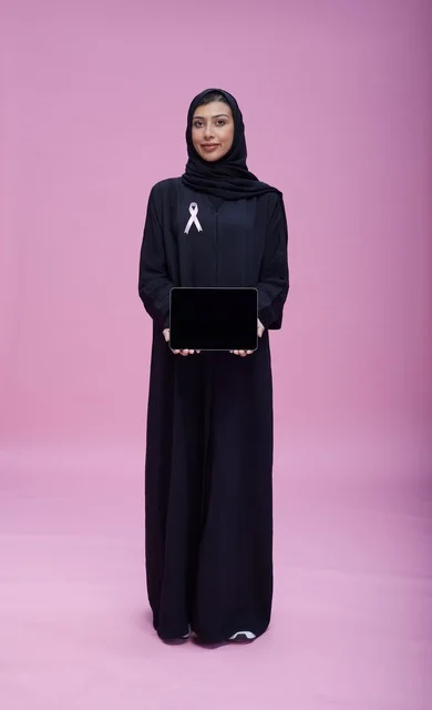 Saudi Woman with Tablet and Breast Cancer Ribbon