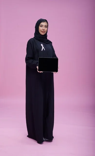 Saudi Woman with Tablet and Breast Cancer Ribbon