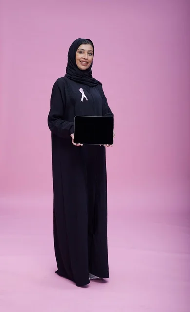 Saudi Woman with Breast Cancer Ribbon and Tablet
