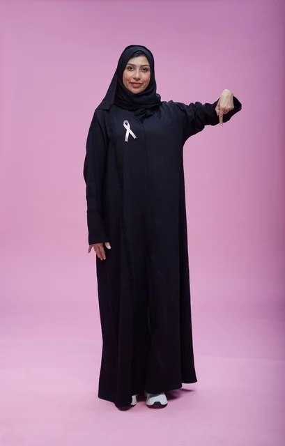 Saudi Woman with Breast Cancer Awareness Ribbon Pink Background