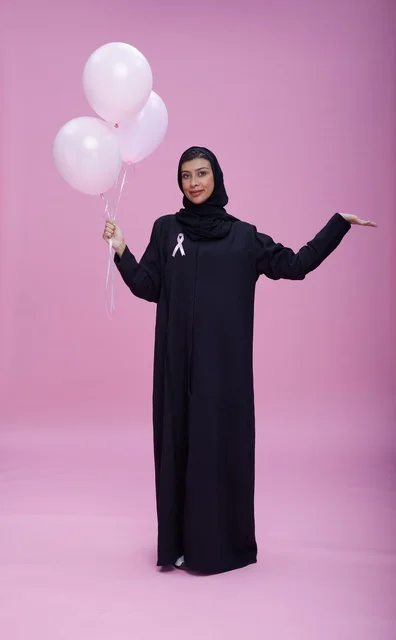 Saudi Woman with Pink Balloons for Breast Cancer Awareness