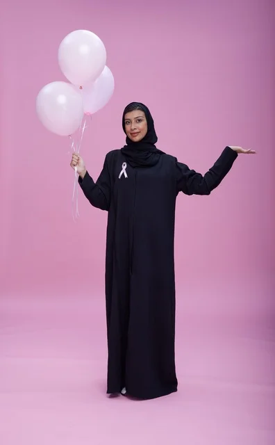 Saudi Woman with Balloons for Breast Cancer Awareness