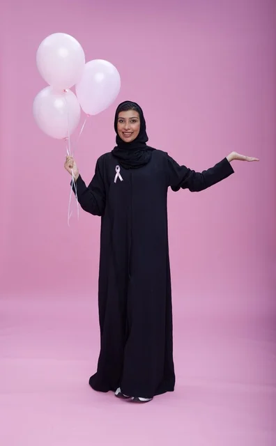 Saudi Woman with Pink Balloons for Breast Cancer Awareness