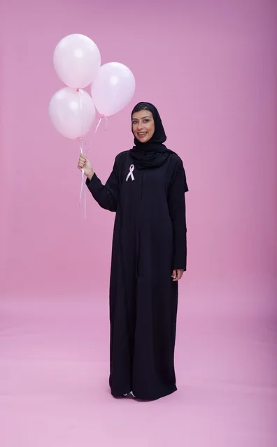 Saudi Woman with Pink Balloons for Breast Cancer Awareness