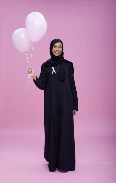 Saudi Woman with Breast Cancer Awareness Balloons
