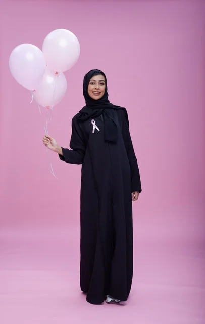 Saudi Woman with Pink Balloons for Breast Cancer Awareness
