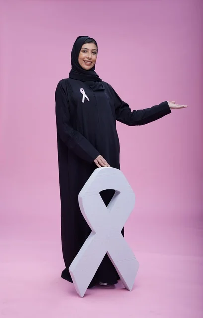 امرأة سعودية مع رمز التوعية بسرطان الثدي