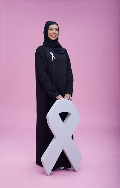 امرأة سعودية مع رمز التوعية بسرطان الثدي
