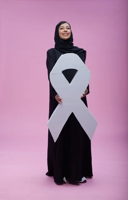 Saudi Woman Holding Breast Cancer Awareness Symbol