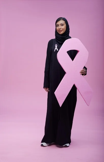 امرأة سعودية تحمل شعار التوعية بسرطان الثدي