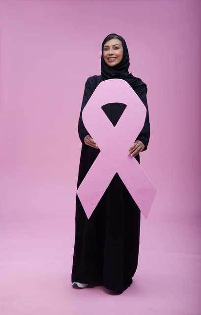 Saudi Woman Holding Pink Breast Cancer Awareness Ribbon