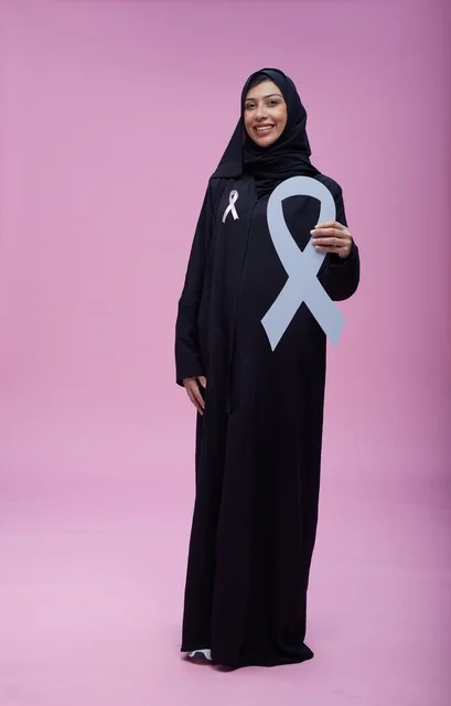 Saudi Woman with Breast Cancer Awareness Ribbon on Pink