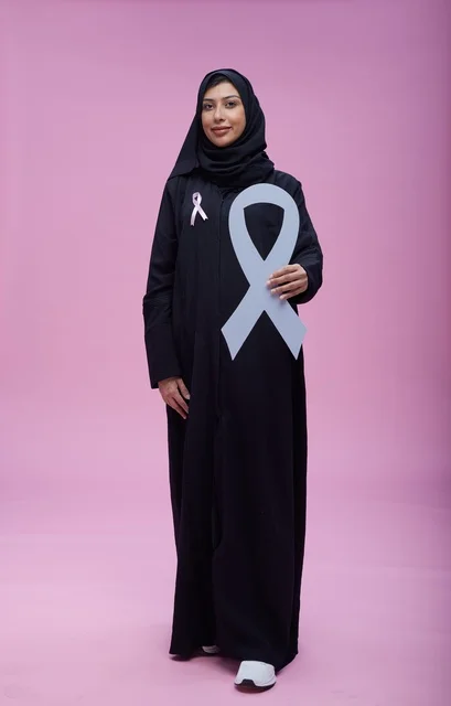 امرأة سعودية تحمل رمز التوعية بسرطان الثدي