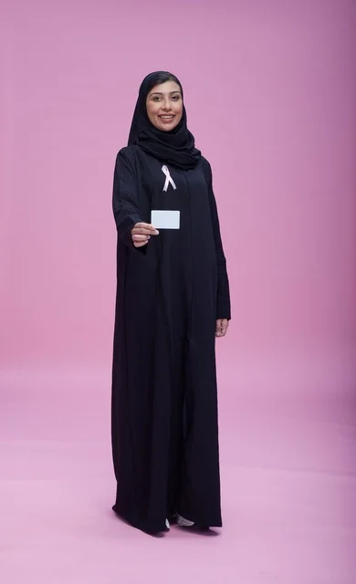 Saudi Woman with Breast Cancer Ribbon on Pink Background
