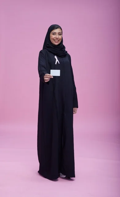Saudi Woman with Pink Ribbon Holding Blank Card