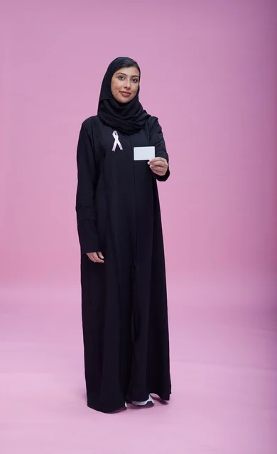 Saudi Woman Holding Awareness Card on Pink Background