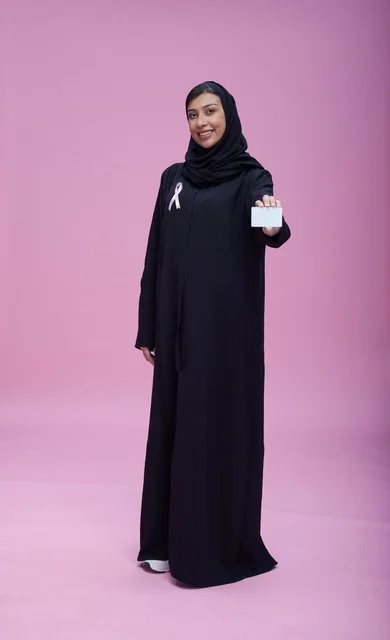 Saudi Woman Holding Card for Breast Cancer Awareness