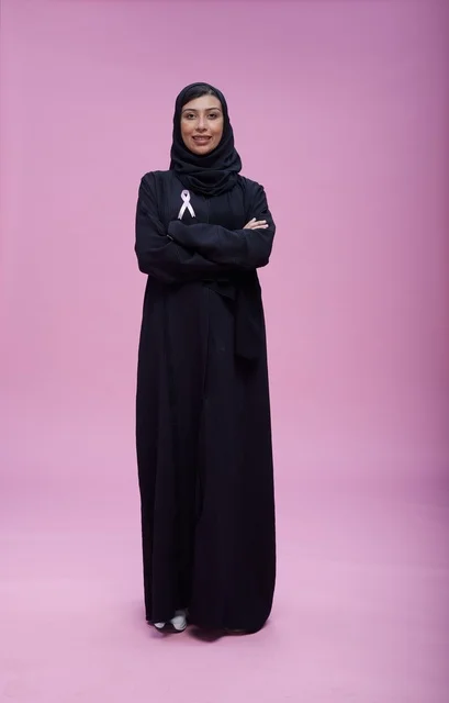 Saudi Woman with Awareness Ribbon on Pink Background