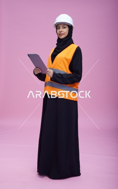 Saudi Female Engineer with Tablet on Pink Background