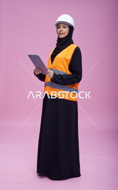 Saudi Female Engineer with Tablet on Pink Background