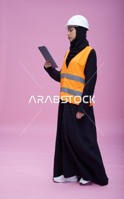 Saudi Female Engineer with Tablet on Pink Background