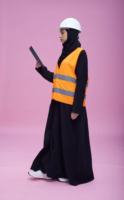 Saudi Female Engineer with Tablet on Pink Background