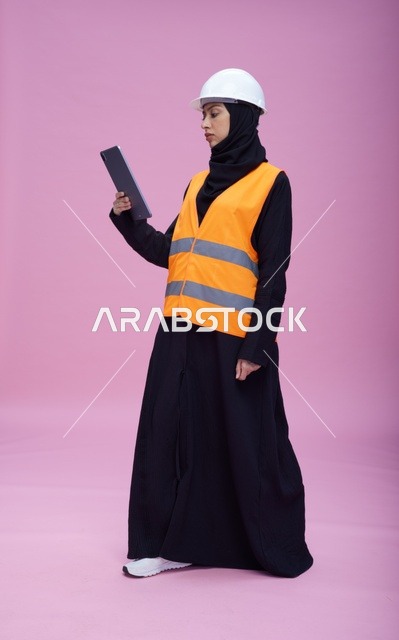 Saudi Female Engineer Using Tablet in Safety Gear