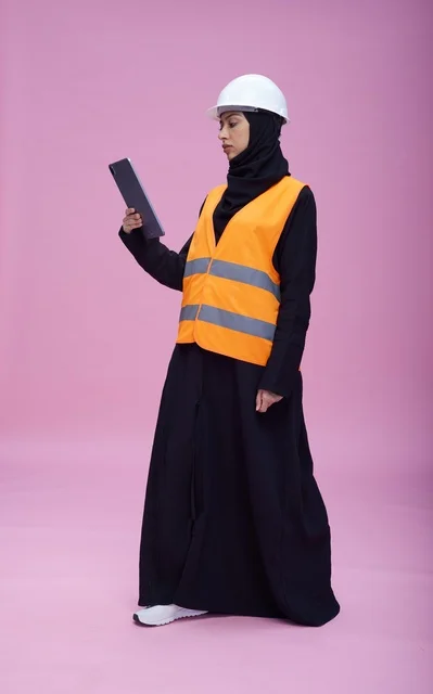 Saudi Female Engineer Using Tablet in Safety Gear