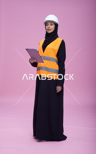 Saudi Female Engineer with Tablet and Safety Gear in Studio