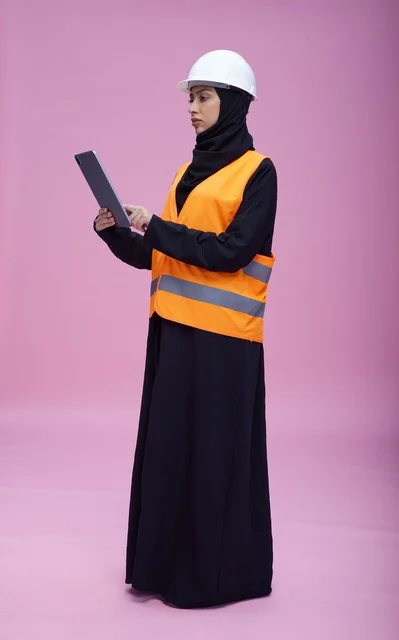 Saudi Female Engineer with Tablet on Pink Background