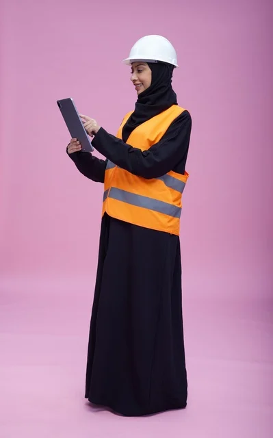 Saudi Female Engineer Using Tablet on Pink Background