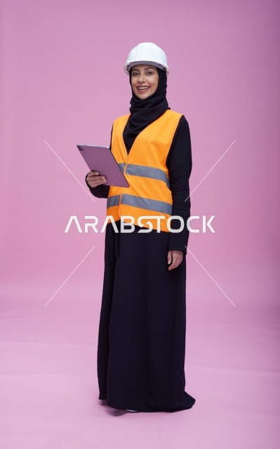 Saudi Female Engineer with Tablet Pink Background