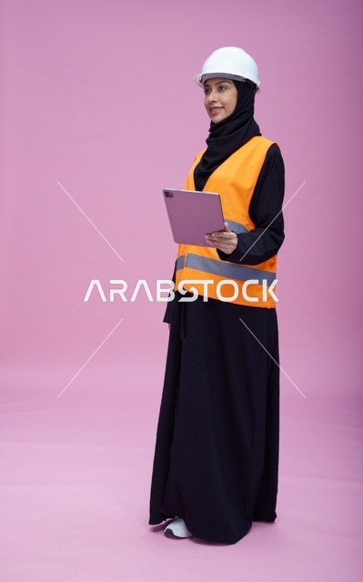 Saudi Female Engineer with Tablet on Pink Background