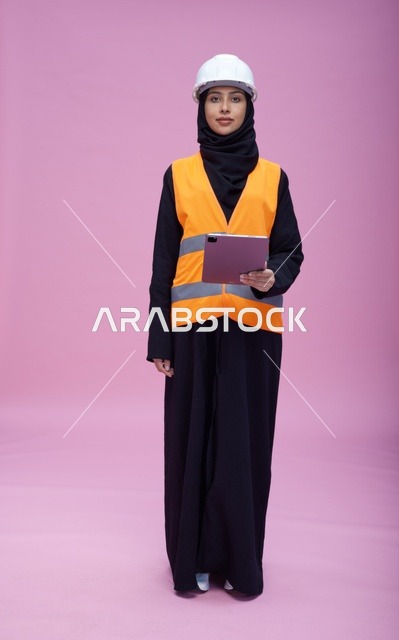 Saudi Female Engineer with Tablet on Pink Background