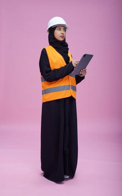 Saudi Female Engineer Using Tablet on Pink Background