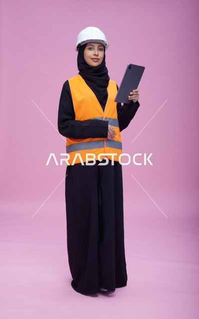 Saudi Female Engineer with Tablet on Pink Background