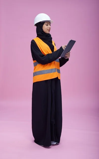 Saudi Female Engineer Using Tablet on Pink Background