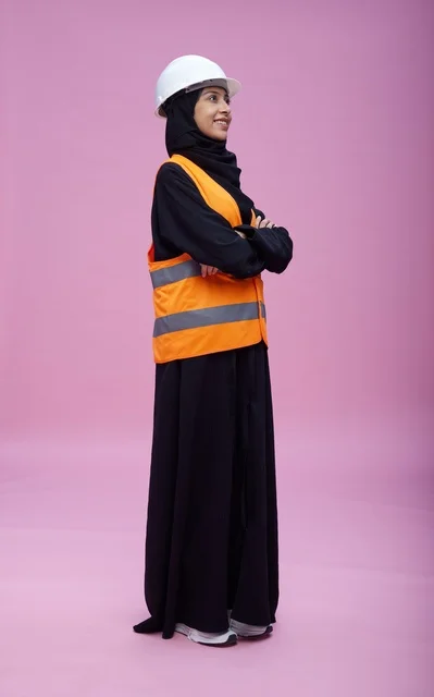 Saudi Female Engineer in Safety Gear on Pink Background