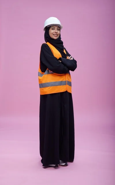 Saudi Female Engineer in Safety Gear on Pink Background