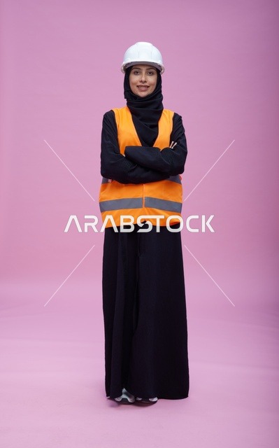 Saudi Female Engineer in Safety Gear on Pink Background