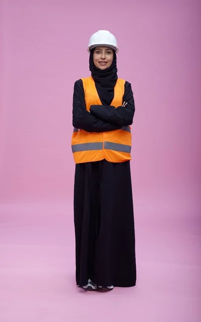 Saudi Female Engineer in Safety Gear on Pink Background