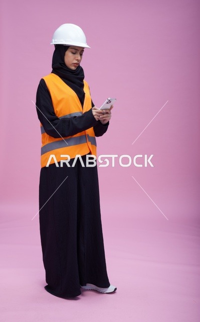 Saudi Female Engineer Using Smartphone in Studio