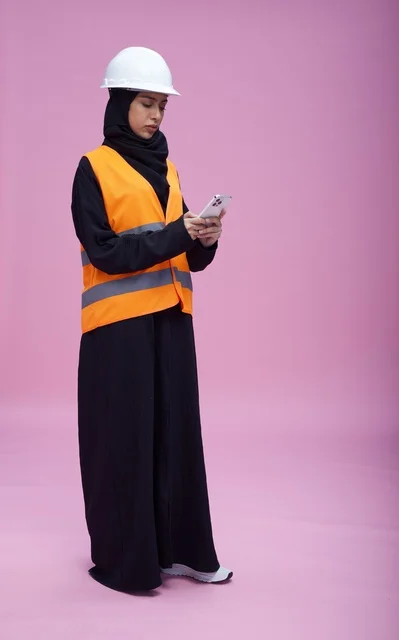 Saudi Female Engineer Using Smartphone in Studio