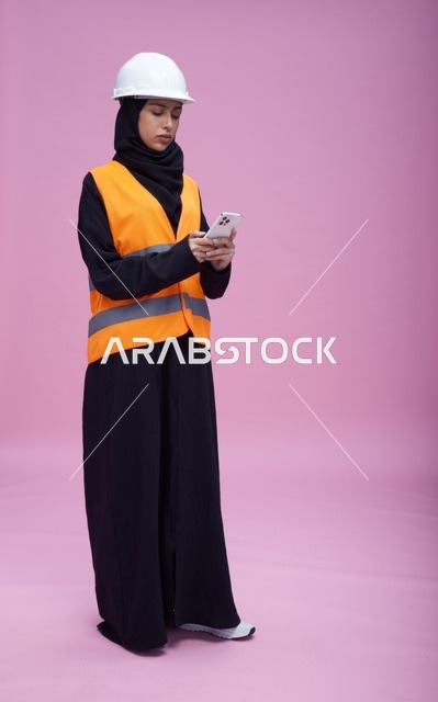 Saudi Female Engineer with Smartphone on Pink Background