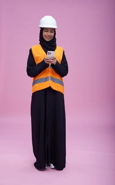 Saudi Female Engineer with Smartphone on Pink Background