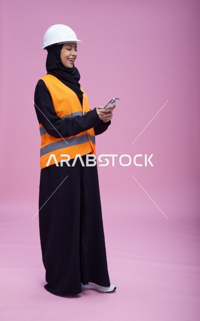 Saudi Female Engineer with Smartphone on Pink Background