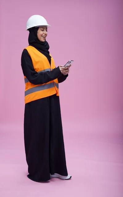 Saudi Female Engineer with Smartphone on Pink Background