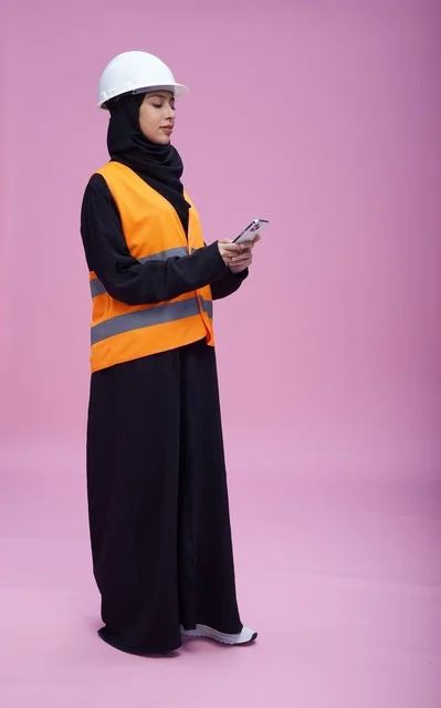 Saudi Female Engineer Using Smartphone on Purple Background